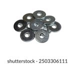 Flat metal penny washers. A scattering of metal washers for bolts and screws. Construction materials and accessories