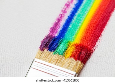 Flat Paintbrush And Multicolor Rainbow Brush Strokes On White Artist Canvas