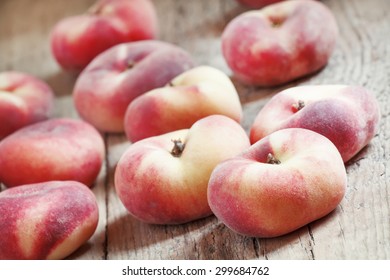 Flat pink peach on an old wooden background, selective focus