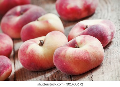 Flat pink peach on an old wooden background, selective focus