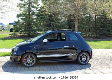 Flat Rock MI: USA: May 1, 2021-Black Abarth Performance Sports Car Known For Its Intense Engine Sound Is Parked At Outdoor Art Fair. Company Logo Is  Scorpion, Founder Carlo Abarth’s Astrological Sign