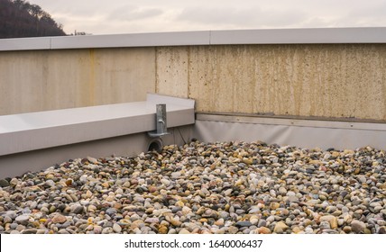 Flat roof with gravel closeup of the drainage