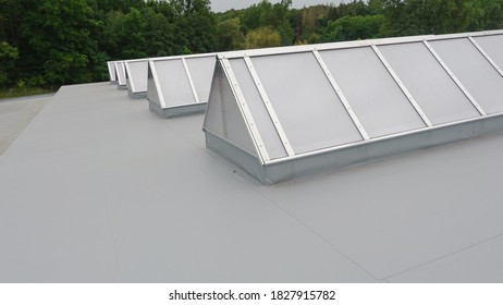 Flat roof with many large skylights on industrial hall 