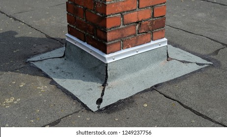 Flat Roof Repair: Flat Roof Chimney Wall Connection With Bitumen Roofing Felt And Flat Roof Cap Strip On A Residential Roof