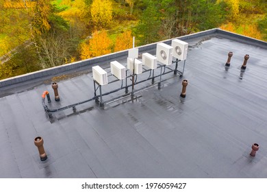 Flat roof with waterproofing Concept housetop covering with waterproofing. Air conditioners on flat roof. Flat roof is covered with waterproofing material. housetop of a large building from a height