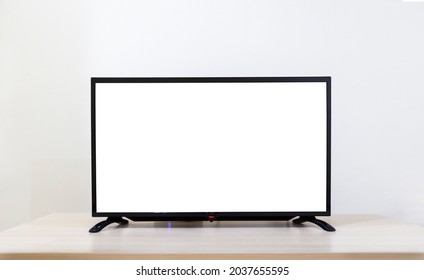 Flat Screen Lcd TV On Table In Living Room On White Wall Background, 4K White Blank HD Monitor Mockup.