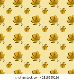 flat seamless pattern of maple leaves on a yellow background