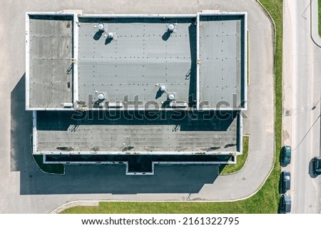 flat shingle roof of industrial building with ventilation systems. aerial top view