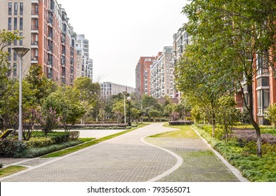 Flat stone pedestrian walkway in an inner courtyard garden with green trees and grass between high-density residential apartment buildings. Ningbo, Zhejiang Province, China. - Powered by Shutterstock