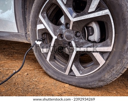 flat suv car tire close-up automatic tire inflation machine inflates the tire, stranded and rescued concept, no people