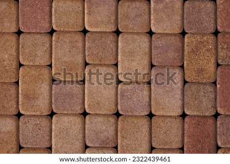 flat texture and full-frame background of brown cuboid concrete brick pavement with rounded corners.