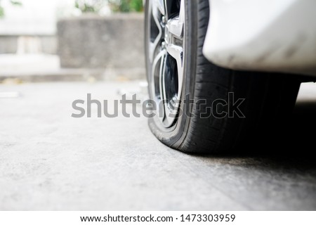 flat tire accident in car park on the street waiting for repair.flat tire and spare concept.copy space, 