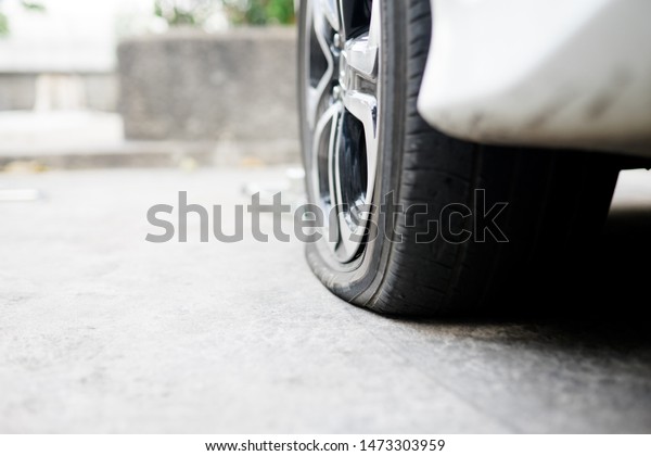 flat tire accident in\
car park on the street waiting for repair.flat tire and spare\
concept.copy space, 
