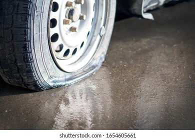 Flat Tire Car On Wet Pavement