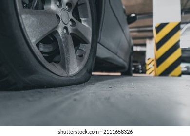 Flat Tire Close Up. Abandoned Car In The Parking Lot.