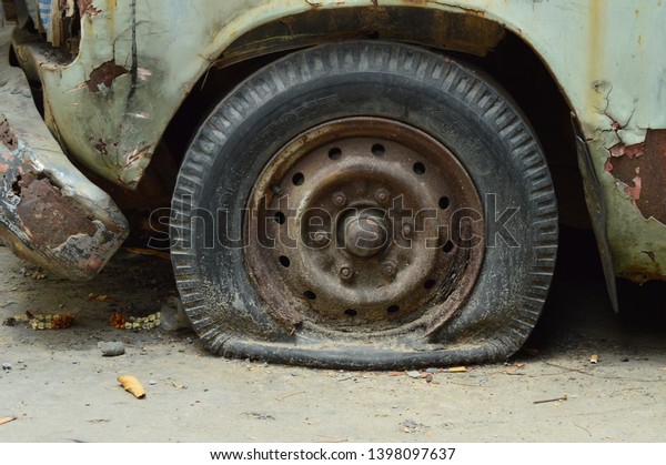 Flat Tire of Old\
Car