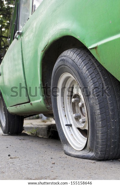 Flat tire of old\
car
