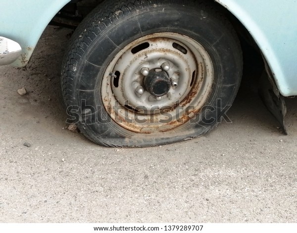 a flat tire. old\
retro wheel. forsaken car