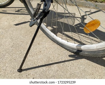 Flat tire on a cycle. Bicycle stands on the bandwagon. A flat tire flattened on the asphalt. A hole in a rubber tire. Reflector Wheel - Shutterstock ID 1723295239