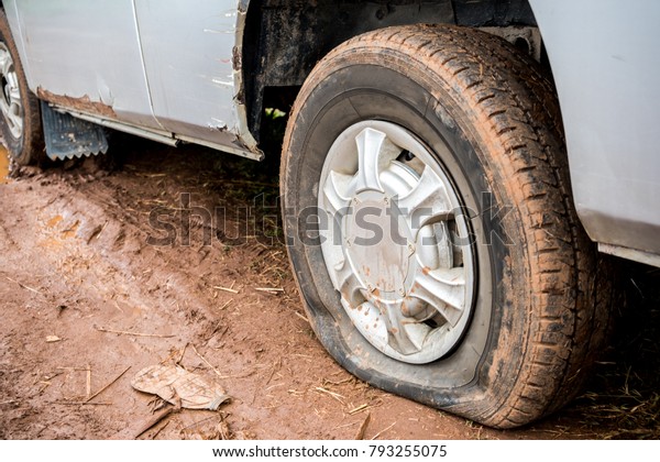 Flat tire on mud\
road