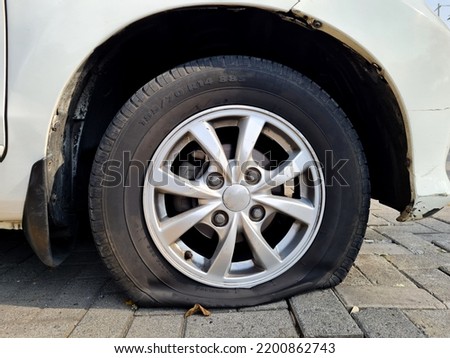 flat tire, reduced car tire pressure due to a leak