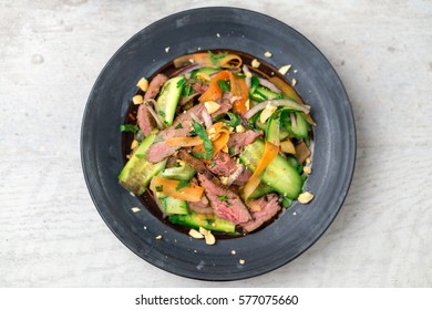 Flat Top View Of An Asian Beef Salad. Inspired By Thai & Vietnamese Cuisine, This Salad Is Made With Fresh Healthy Vegetables (carrots, Onions, Cucumber, Etc) And A Nicely Seared Flank Steak