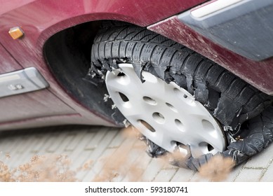 Flat And Torn Tire On A Car