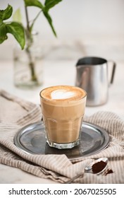 Flat white coffee with heart shaped milk and coffee powder - Shutterstock ID 2067025505