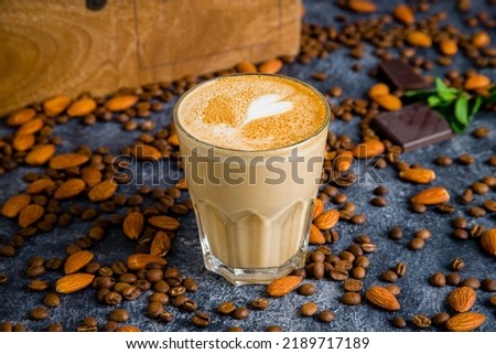 flat white coffee on glass on grey table