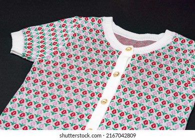 Flat White Knitwear Pink Red Flower Pattern Sweater Tshirt Shape With Pearl And Gold Circle Buttons On Black Background With Studio Light