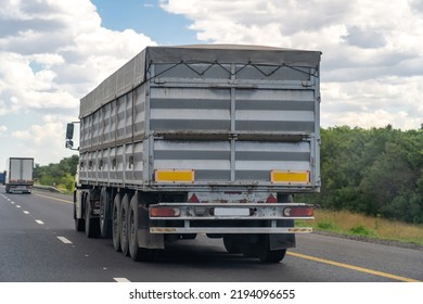 Flatbed Lorry With Elongated Grey Body On Countryside Road 