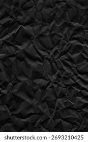 Flatbed scanner scan of crumpled matte black paper with deep creases, random folds and strong shadow variation across the surface. The crumpling creates a three-dimensional relief visible as tonal contrast between raised peaks and folded valleys. Matte black paper absorbs light differently from standard paper, giving the shadows extra depth. No AI, no digital generation, no 3D rendering. 5000x7500px at 300dpi, print-ready. Works as background, overlay or displacement map for dark poster design, album covers, packaging, editorial and product mockups. The crease pattern gives natural compositional movement and depth. Also useful as a displacement map in Photoshop for wrapping text or graphics onto a crumpled surface.