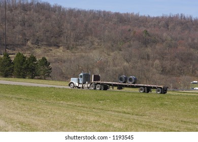 Flatbed Semi Hauling Sheet Metal Or Rolls