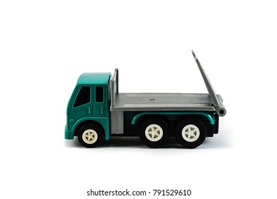 A Flatbed Towing Truck Toy Side Profile On A White Background. Towing Gate Up.