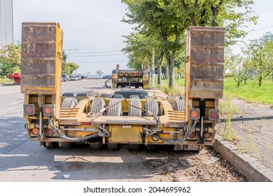 Flatbed Trail Used To Haul Heavy Equipment Parked On Side Of Road In Industrial Park