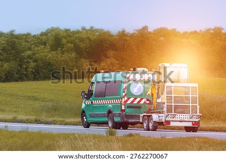 Flatbed trailers moving heavy construction vehicles