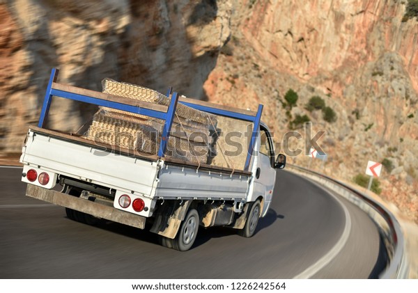 flatbed truck with\
cargo in mountains road