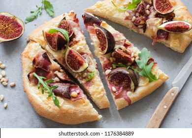 Flatbread With Figs, Ham, Cheese And Arugula. Gourmet Pizza With Prosciutto. Closeup View