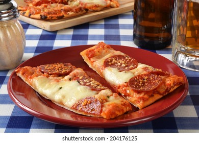 Flatbread Garlic And Pepperoni Pizza On A Picnic Table With Beer