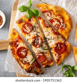 Flatbread Pepperoni Pizza Topped With Fresh Basil Sliced, Top View