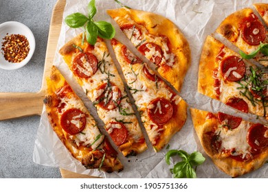 Flatbread Pepperoni Pizza Topped With Fresh Basil Sliced, Top View