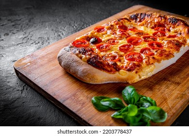 Flatbread Pizza With Mozzarella Cheese, Tomatoes, Pepper, Spices And Fresh Basil. Italian Pizza. Pizza Margherita Or Margarita On Dark Grey Black Slate Background