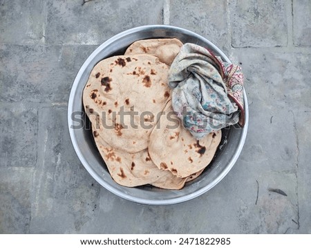 Flatbread (Roti). Roti is a round flatbread. Made from whole wheat flour dough. Bread is baked in the oven by kneading flour. Salted bread. Horizontal, landscape image. Close-up of chapati. Top view