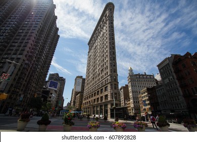 Flatiron building and buildings in Manhattan with blue sky - Powered by Shutterstock