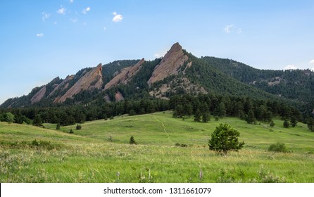 The Flatirons in Boulder, Colorado with Hiking Trail and Pine Trees taken from Chautauqua Park, Clear Day, Very Light Clouds, Summer 2017 