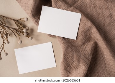 Flatlay Of Aesthetic Parisian Styled Business Branding Template. Blank Paper Sheet Card With Mockup Copy Space, Dry Flowers Branch And Cloth On Neutral Beige Background. Flat Lay, Top View