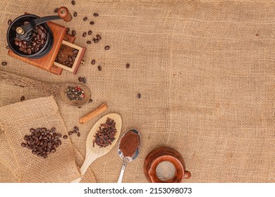 Flat-lay Antique Manual  Wood Coffee Burr Grinder Against A Burl