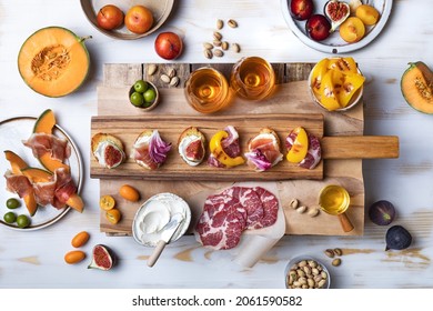 Flat-lay of appetizers table with italian antipasti snacks. Holiday gathering, wine and snacks party. Brushetta or authentic traditional spanish tapas set over wooden background.