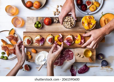 Flat-lay Of  Appetizers Table With Italian Antipasti Snacks. Family, Friends Holiday Gathering, Wine And Snacks Party. Brushetta Or Authentic Traditional Spanish Tapas Set Over Wooden Background. 