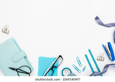 Flatlay Arrangement With Various Office And Stationary Tools On White: Planner, Note Paper, Pens, Glasses Etc. Copyspace. Stylish Business Mockup With Blue Accessories